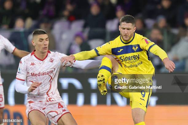 Nikola Milenkovic of ACF Fiorentina battles for the ball with Thomas Henry of Hellas Verona during the Serie A TIM match between ACF Fiorentina and...