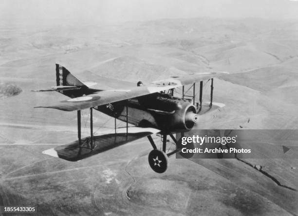 American pilot, racing driver and Medal of Honor recipient Eddie Rickenbacker flying a SPAD SXIII single engine biplane fighter aircraft from the...