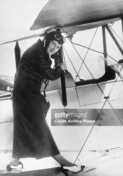 Portrait of Alice Jessie Fawsitt, the fist woman pilot with Britain's Civil Air Guard, climbs into the cockpit of a de Havilland Moth two-seat...