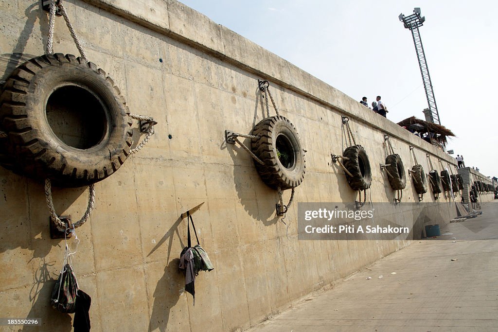 Tyres hanging on a wall  to protect boats when docking wait...