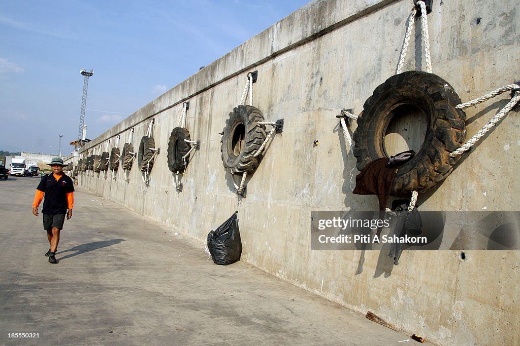 Tyres hanging on a wall  to protect boats when docking wait...