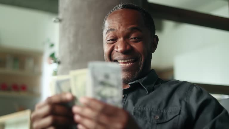 https://media.gettyimages.com/id/1855509461/video/mature-african-american-man-counting-stack-of-dollars-banknotes-at-home.jpg?b=1&s=640x640&k=20&c=cKDJcuCh83aw5n1i4kgG9FA7Fl2U0yC7ahedQv-GL3k=