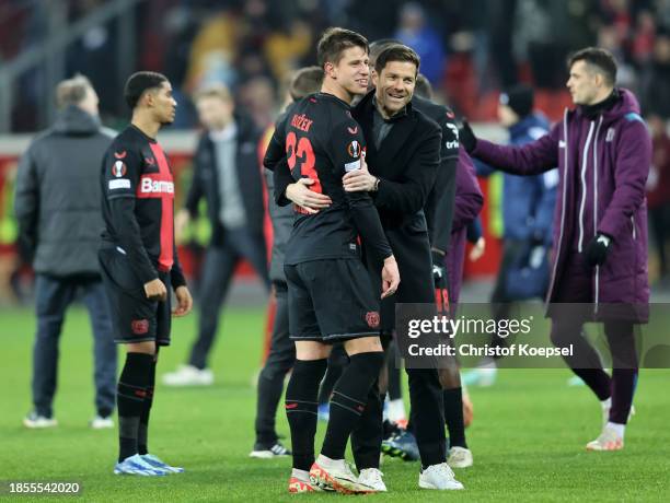 Adam Hlozek celebrates with Xabi Alonso, Head Coach of Bayer Leverkusen, after the team's victory during the UEFA Europa League match between Bayer...