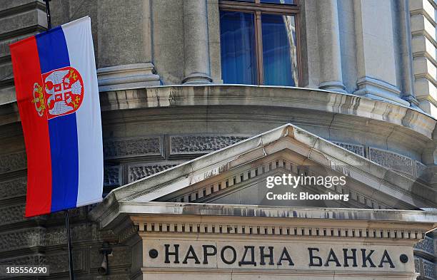 The Serbian national flag flies outside Serbia's central bank, in Belgrade, Serbia, on Sunday, Oct. 20, 2013. Serbia's government revealed a salvo of...