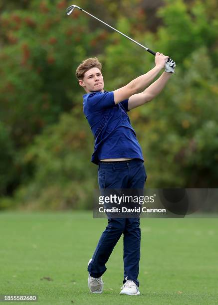 Ciaran Harrington of Ireland who will be playing with his father Padraig Harrington plays a shot during the pro-am as a preview for the PNC...
