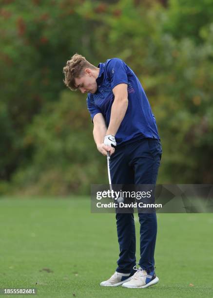 Ciaran Harrington of Ireland who will be playing with his father Padraig Harrington plays a shot during the pro-am as a preview for the PNC...