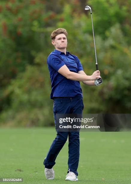 Ciaran Harrington of Ireland who will be playing with his father Padraig Harrington plays a shot during the pro-am as a preview for the PNC...