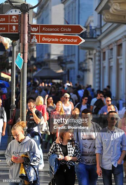 Pedestrians pass along a shopping street in Belgrade, Serbia, on Sunday, Oct. 20, 2013. Serbia's government revealed a salvo of measures to bring the...