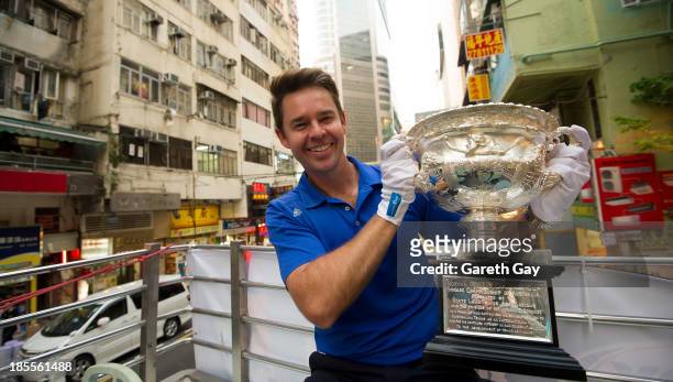 Todd Woodbridge poses for the press, with the AO men's trophy in Hong Kong, during the Australian Open Trophy tour on October 22, 2013 in Hong Kong,...