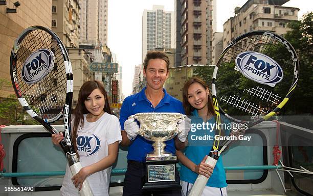 Todd Woodbridge poses for the press, with the AO men's trophy in Hong Kong, during the Australian Open Trophy tour on October 22, 2013 in Hong Kong,...