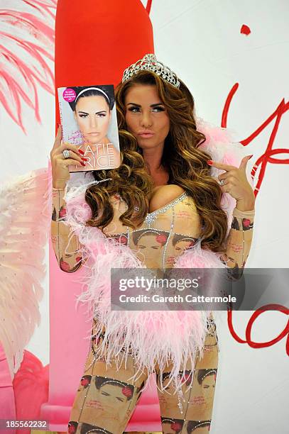 Katie Price poses at a photocall to launch her autobiography - 'Love, Lipstick And Lies' at The Worx on October 22, 2013 in London, England.
