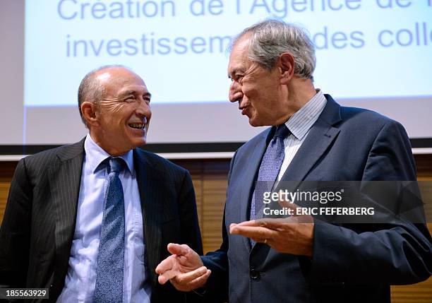 Mayor of Lyon Gerard Collomb talks with the president of the French mayors' association Jacques Pelissard during a press conference on October 22,...