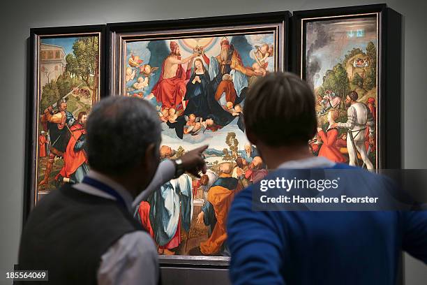 Visitors look at The Heller Altar triptych painting at the Albrecht Durer exhibition in the Staedel museum, on October 22, 2013 in Frankfurt am Main,...