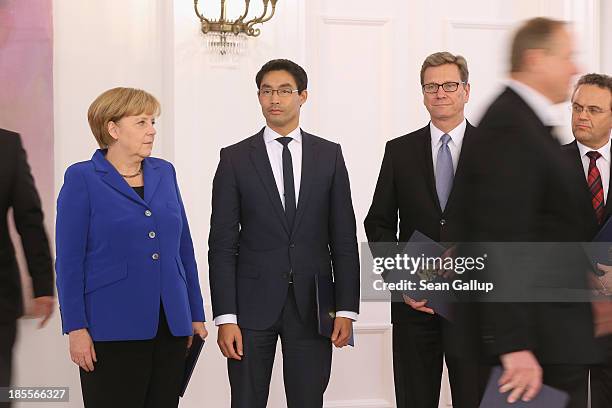 German Chancellor Angela Merkel stands with Vice Chancellor and Economy Minister Philipp Roesler and Foreign Minister Guido Westerwelle , who are...