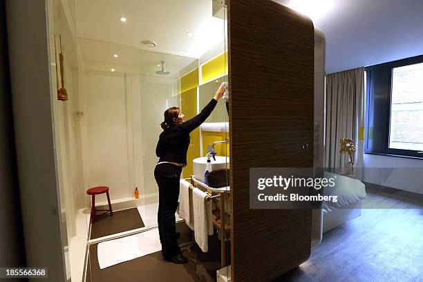 Chambermaid cleans the bathroom of a room at the Qbic Hotel London City, operated by Qbic Hotels, in London, U.K., on Tuesday, Oct. 22, 2013. U.K....