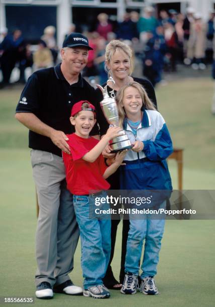 Mark O'Meara of the United States celebrates with his wife Alicia, son Shaun and daughter Michelle as they holf the trophy after his victory at the...