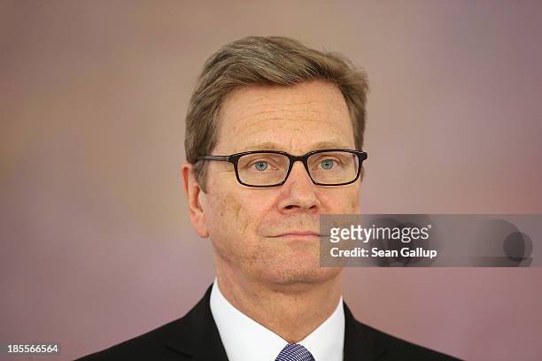 Outgoing German Foreign Minister Guido Westerwelle, who is a member of the German Free Democrats , waits to receive his dismissal certificate from...