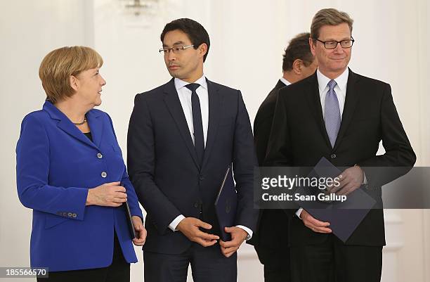 German Chancellor Angela Merkel stands with Vice Chancellor and Economy Minister Philipp Roesler and Foreign Minister Guido Westerwelle , who are...