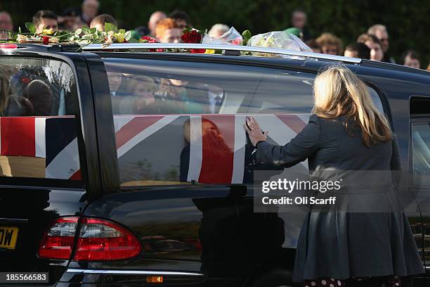 Sharon Brynin, the mother of Lance corporal James Brynin, pays tribute as his coffin passes through Carterton, after the soldier was repatriated at...