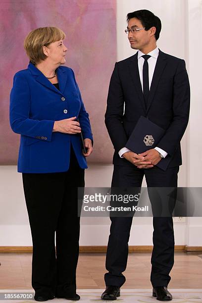 German Chancellor Angela Merkel looks at Vice Chancellor and Economy Minister Philipp Roesler, who is a member of the German Free Democrats , before...
