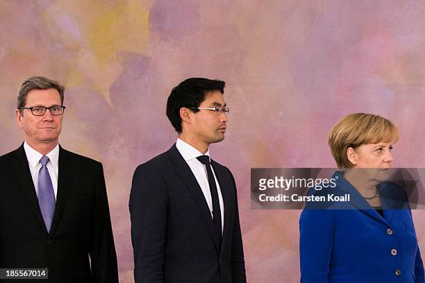 German Chancellor Angela Merkel stands with Vice Chancellor and Economy Minister Philipp Roesler and Foreign Minister Guido Westerwelle , who are...