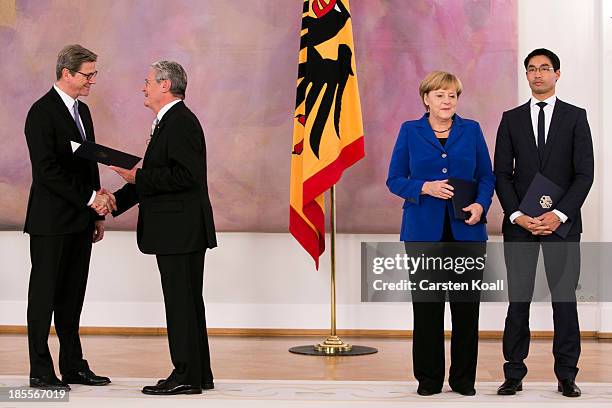 German President Joachim Gauck hands outgoing Foreign Minister Guido Westerwelle , who is also a member of the German Free Democrats , his dismissal...