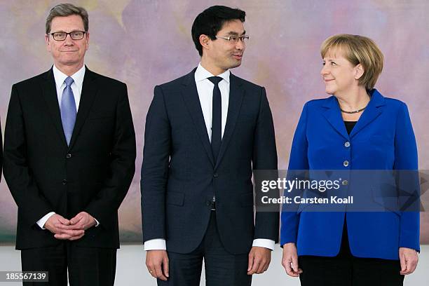 German Chancellor Angela Merkel stands with Vice Chancellor and Economy Minister Philipp Roesler and Foreign Minister Guido Westerwelle , who are...