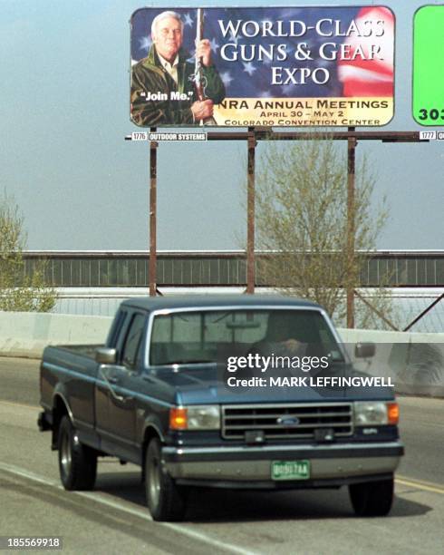 Truck passes a billboard 24 April 1999, announcing the upcoming National Rifle Association annual meeting to be held in Denver, Colorado 30 April -...