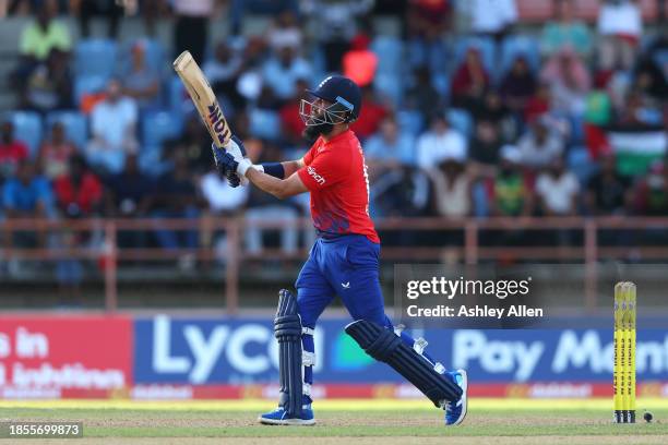 Moeen Ali of England hits a six in the final over during the 2nd T20 International match between West Indies and England at the National Cricket...