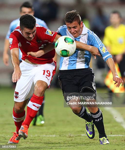 Daniel Ripic of Austria vies for the ball against Nicolas Tripichio of Argentina during their FIFA U17 World Cup football match at the Rashid Stadium...