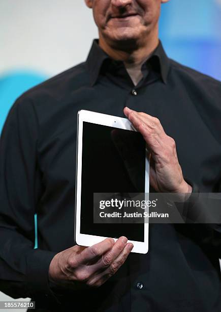 Apple CEO Tim Cook holds the new iPad Air during an Apple announcement at the Yerba Buena Center for the Arts on October 22, 2013 in San Francisco,...