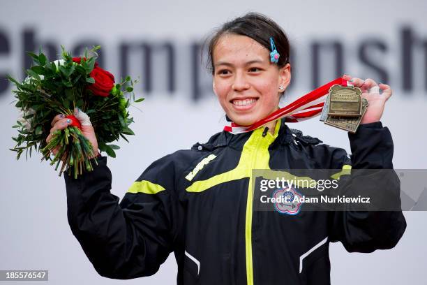 Hsing Chun Kuo from Taipei poses with the gold medal in total competition women's 58 kg Group A during the medal ceremony during the IWF World...