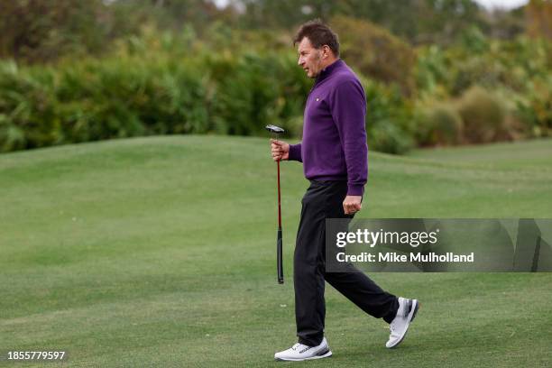 Sir Nick Faldo of England walks to his cart after playing the fifth hole prior to the PNC Championship at The Ritz-Carlton Golf Club on December 14,...