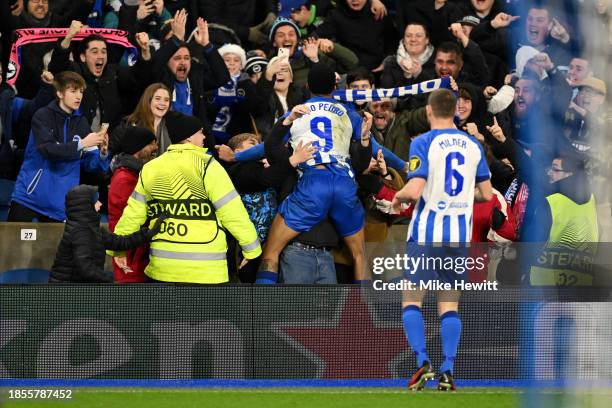 Joao Pedro of Brighton & Hove Albion celebrates with the fans after scoring their team's first goal during the UEFA Europa League match between...