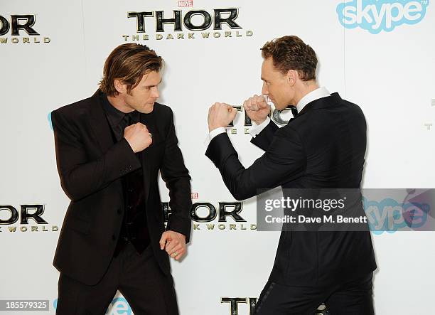 Chris Hemsworth and Tom Hiddleston attend the World Premiere of "Thor: The Dark World" at Odeon Leicester Square on October 22, 2013 in London,...