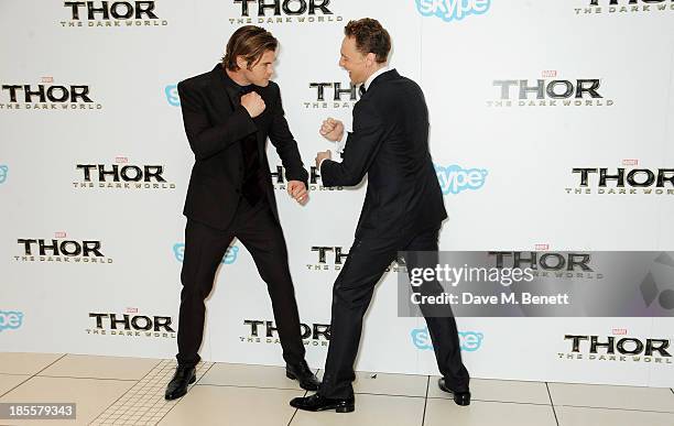 Chris Hemsworth and Tom Hiddleston attend the World Premiere of "Thor: The Dark World" at Odeon Leicester Square on October 22, 2013 in London,...