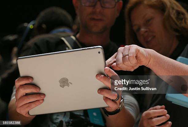 Attendees look at the new iPad Air during an Apple announcement at the Yerba Buena Center for the Arts on October 22, 2013 in San Francisco,...