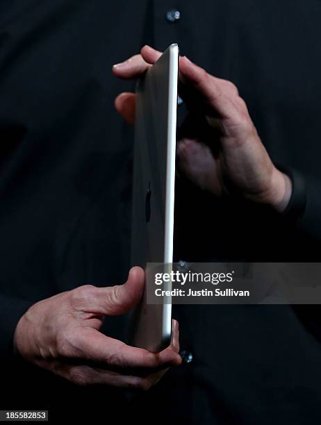 Apple CEO Tim Cook holds the new iPad Air during an Apple announcement at the Yerba Buena Center for the Arts on October 22, 2013 in San Francisco,...