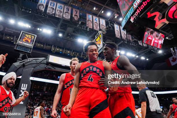 Scottie Barnes of the Toronto Raptors celebrates with teammate Pascal Siakam after making a basket against the Atlanta Hawks during second half NBA...