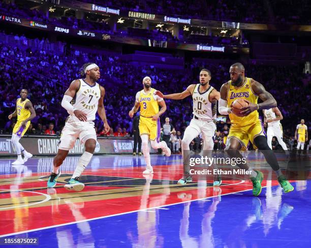 LeBron James of the Los Angeles Lakers drives against Buddy Hield of the Indiana Pacers in the first quarter of the championship game of the...