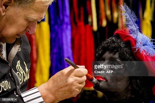Woman has her face painted to become Zwarte Piet in Soest on October 22, 2013. Zwarte Piet is, as part of the Dutch tradition, the companion of...