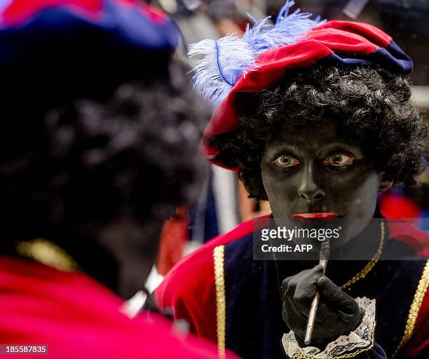 Woman has her face painted to become Zwarte Piet in Soest on October 22, 2013. Zwarte Piet is, as part of the Dutch tradition, the companion of...