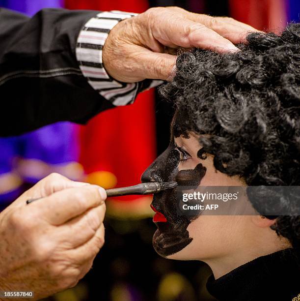 Woman has her face painted to become Zwarte Piet in Soest on October 22, 2013. Zwarte Piet is, as part of the Dutch tradition, the companion of...