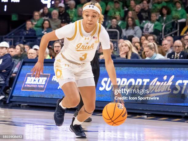 Notre Dame Fighting Irish guard Hannah Hidalgo dribbles the ball toward the basket during a college basketball game between the Purdue Boilermakers...