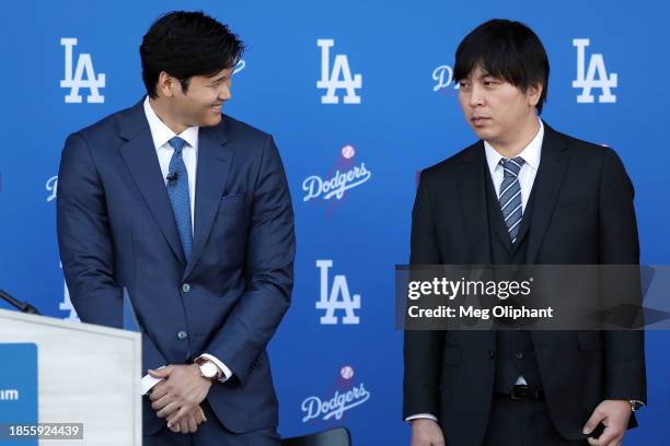 Shohei Ohtani speaks with his interpreter Ippei Mizuhara prior to being introduced by the Los Angeles Dodgers at Dodger Stadium on December 14, 2023...