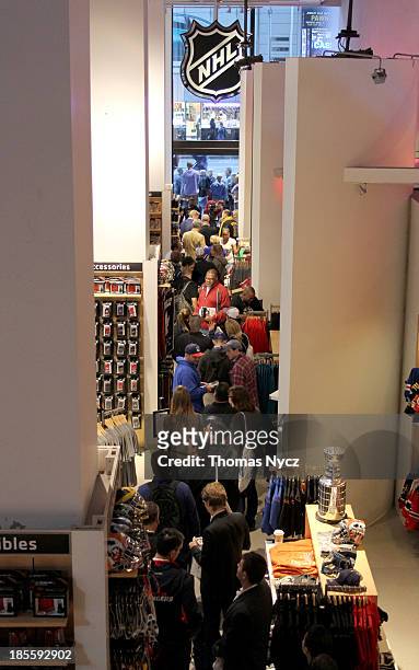 Fans wait in line for Bobby Orr to sign their copies of the new book "Orr: My Story" at the NHL Powered by Reebok Store on October 22, 2013 in New...