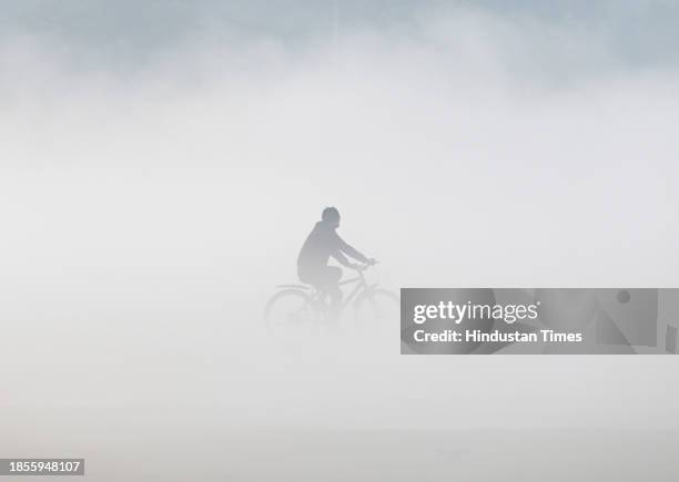 People playing on the ground in a foggy morning, on December 16, 2023 in Noida, India.