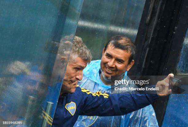 Former Boca Juniors player and head coach of Platense Martin Palermo takes a selfie with a fan as leaving the Estadio Alberto J. Armando after voting...