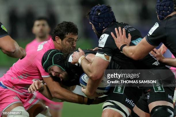 Leicester Tigers' South African lock Kyle Hatherell is tackled during the European Champions Cup first round Day 2 Pool 4 Rugby Union match between...