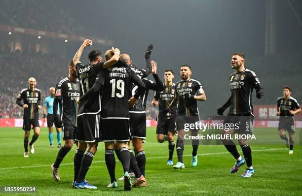 Benfica's Danish forward Casper Tengstedt celebrates scoring the opening goal with teammates during the Portuguese League football match between SC...